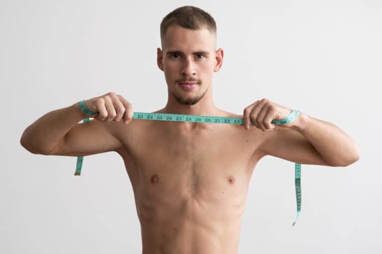 shirtless-man-holding-measuring-tape